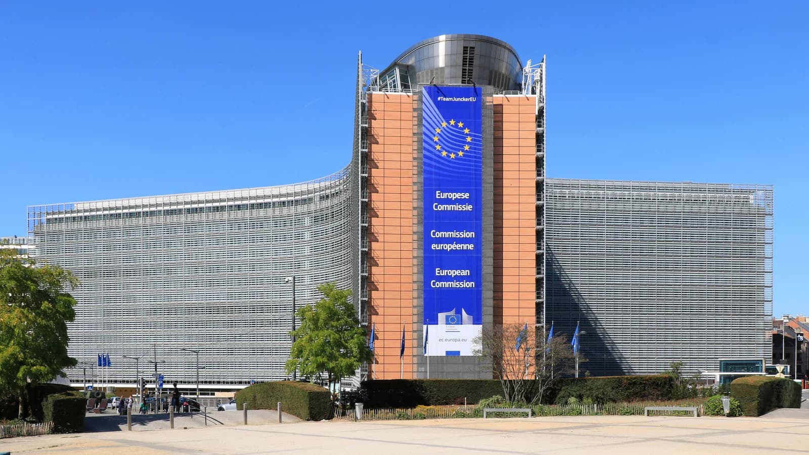 Фасад здания Berlaymont в Брюсселе с вертикальным баннером Европейской комиссии.